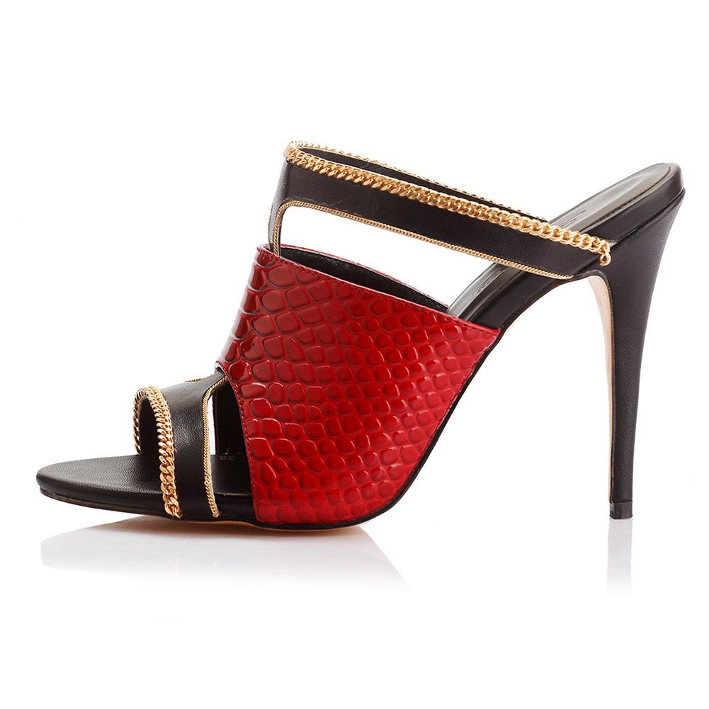 Red high-heeled shoe with black and gold accents on a white background